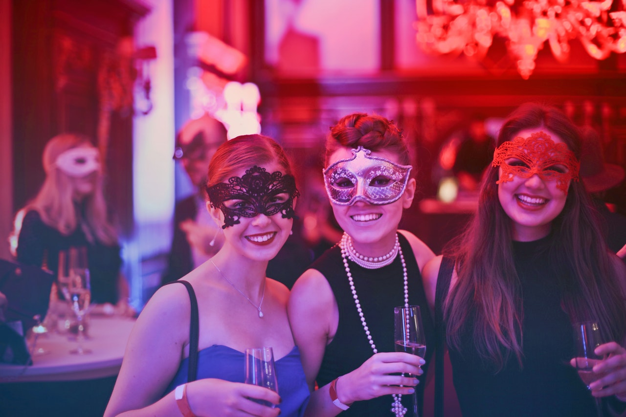 women wearing masks at a party